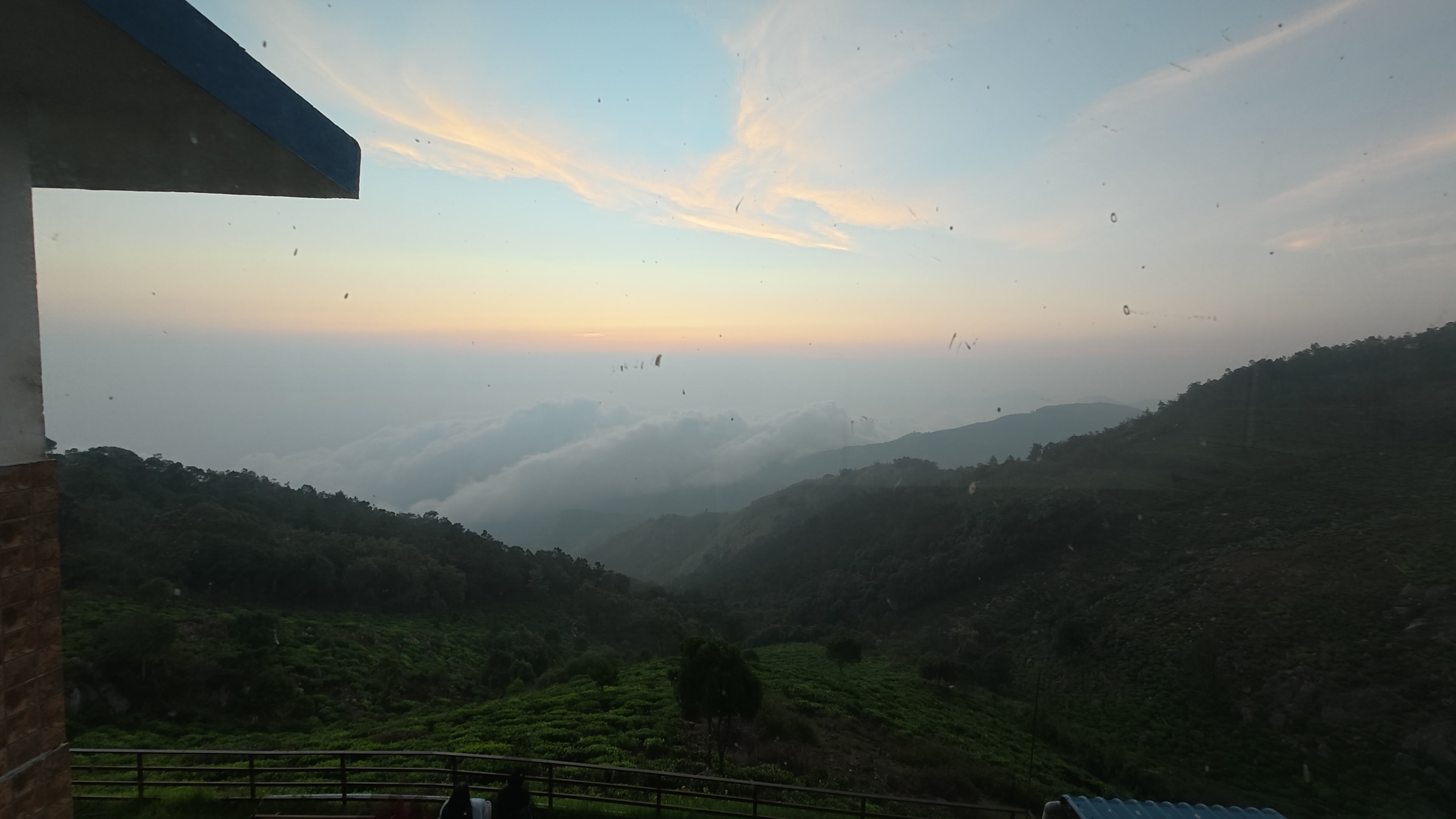Raw sunrise time-lapse frame with many fixed dirt and water spots across the sky